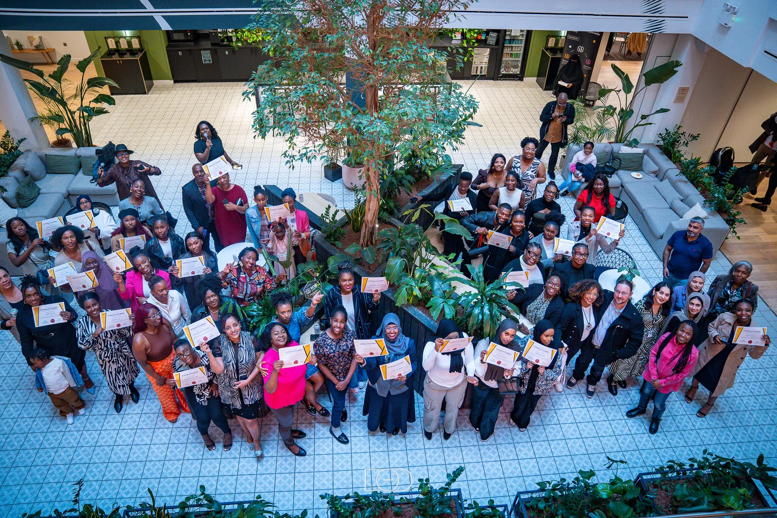 Niyo graduates holding their certificates of completion